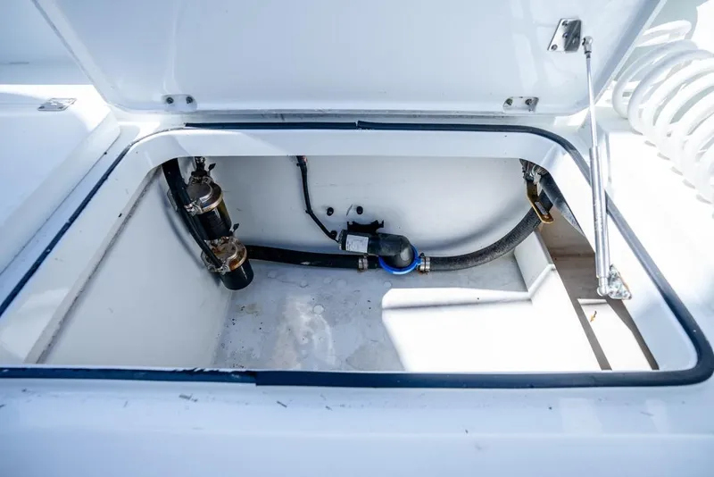Slide: The Image of Open storage compartment in 2018 Freeman 37VH boat, showing internal components and wiring. - 48