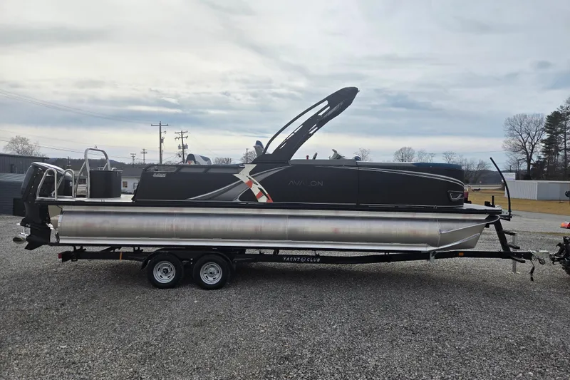 Slide: The Image of 2026 Avalon Platinum LSZ 2585 Cruise Rear Bench pontoon boat on trailer, overcast sky. - 3