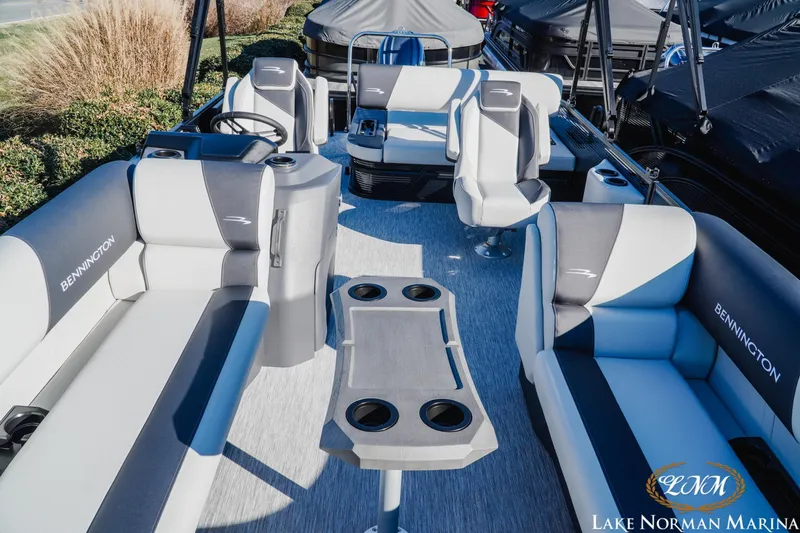 Slide: The Image of 2026 Bennington 22SSB SNAP pontoon boat interior with plush seating and cup holders. - 14