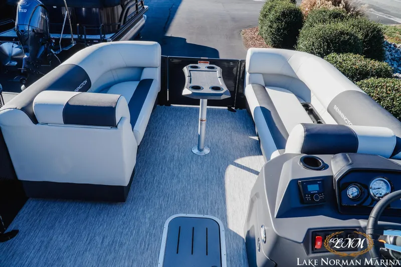 Slide: The Image of 2026 Bennington 22SSB SNAP pontoon boat interior with plush seating and modern dashboard. - 7