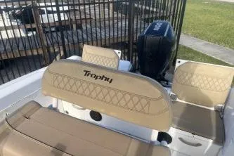 Slide: The Image of 2022 Trophy T22 boat interior with beige seating and outboard motor. - 12