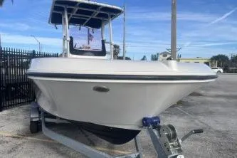 Slide: The Image of 2022 Trophy T22 boat on trailer, parked outdoors under clear blue sky. - 4