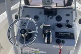 Slide: The Image of 2022 Trophy T22 boat dashboard with steering wheel and control panel. - 9