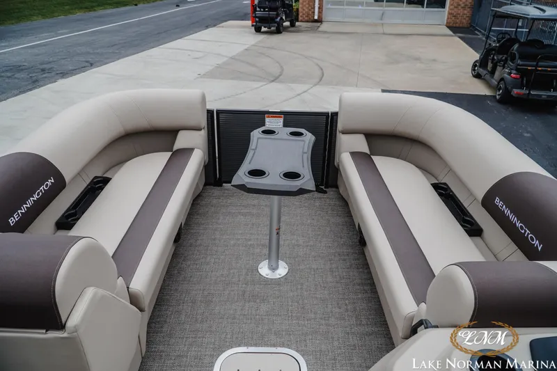 Slide: The Image of 2026 Bennington 23SSR pontoon boat interior with plush seating and central table. - 12