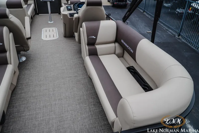 Slide: The Image of 2026 Bennington 23SSR pontoon boat interior with beige and brown seating at Lake Norman Marina. - 7