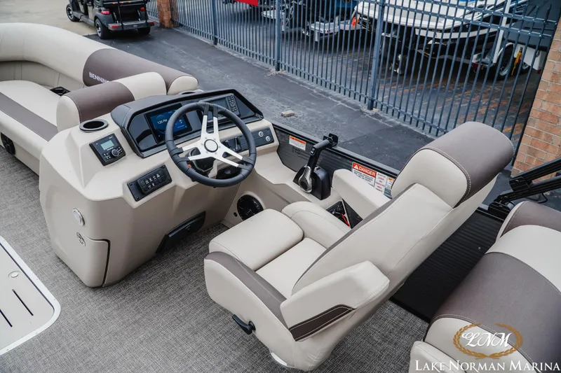 Slide: The Image of 2026 Bennington 23SSR boat interior with steering wheel and seating at Lake Norman Marina. - 9