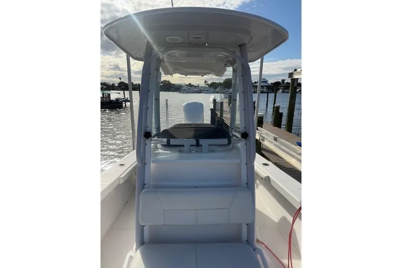 Slide: The Image of 2021 Everglades 243 Center Console boat docked by the water. - 21
