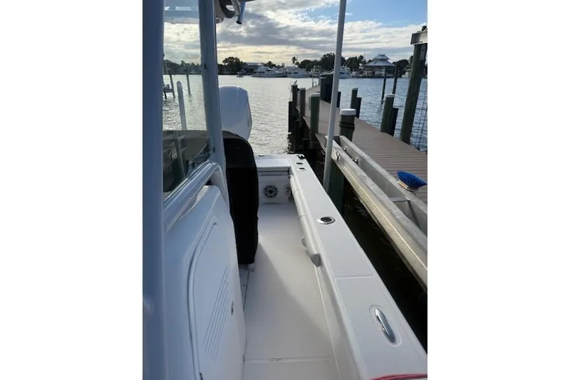 Slide: The Image of 2021 Everglades 243 Center Console boat docked by the water. - 23