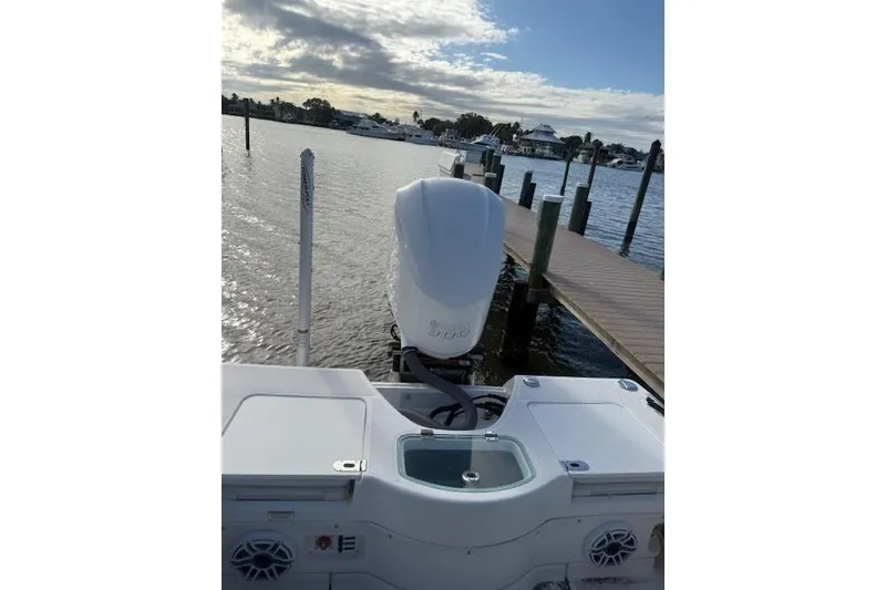Slide: The Image of 2021 Everglades 243 Center Console boat docked by a scenic waterfront. - 25