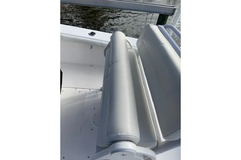 Slide: The Image of 2021 Everglades 243 Center Console boat seating, featuring sleek white upholstery. - 26