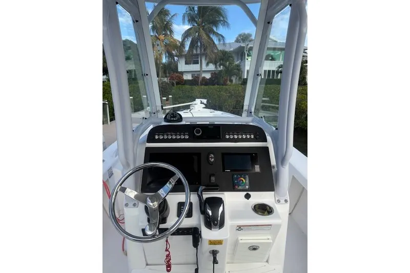 Slide: The Image of 2021 Everglades 243 Center Console boat dashboard with steering wheel and controls. - 27