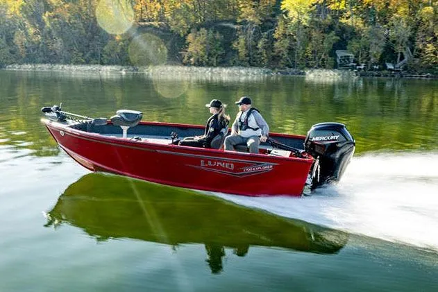 Slide: The Image of 2026 Lund 1700 Explorer Tiller boat on trailer in garage setting. - 1