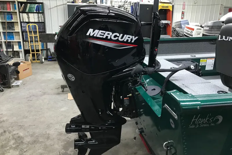 Slide: The Image of 2026 Lund 1700 Explorer Tiller with Mercury outboard motor in a workshop setting. - 10