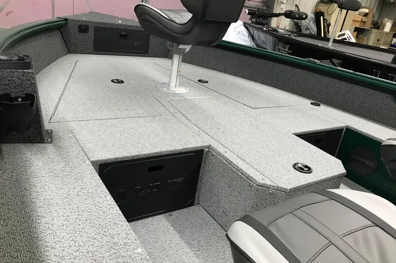 Slide: The Image of 2026 Lund 1700 Explorer Tiller boat interior with seating and storage compartments. - 15