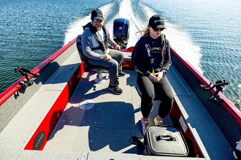 Slide: The Image of 2026 Lund 1700 Explorer Tiller boat, green exterior, on trailer in garage setting. - 5