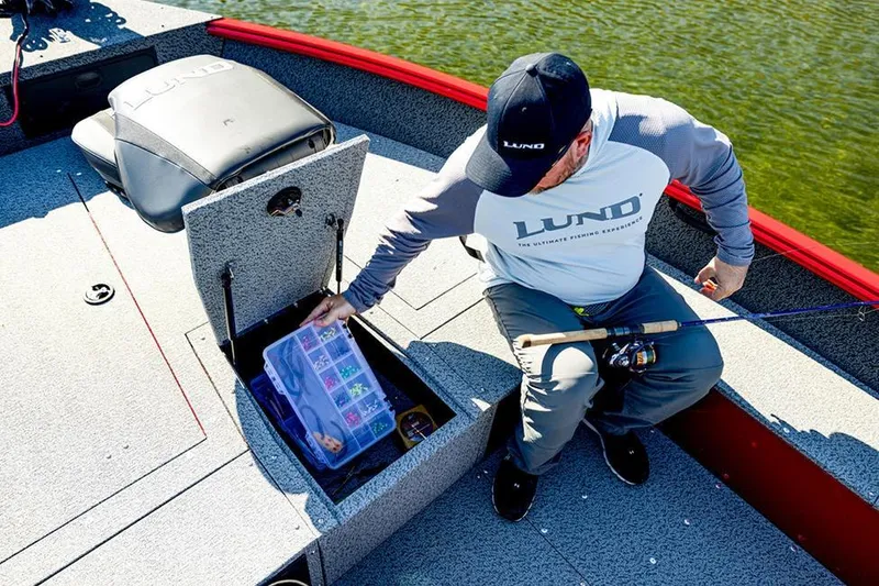 Slide: The Image of 2026 Lund 1700 Explorer Tiller boat in showroom, featuring sleek design and comfortable seating. - 6