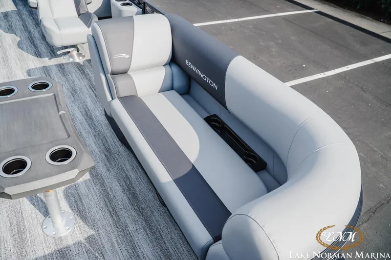 Slide: The Image of 2026 Bennington 22SSR boat interior with gray seating and cupholders at Lake Norman Marina. - 16