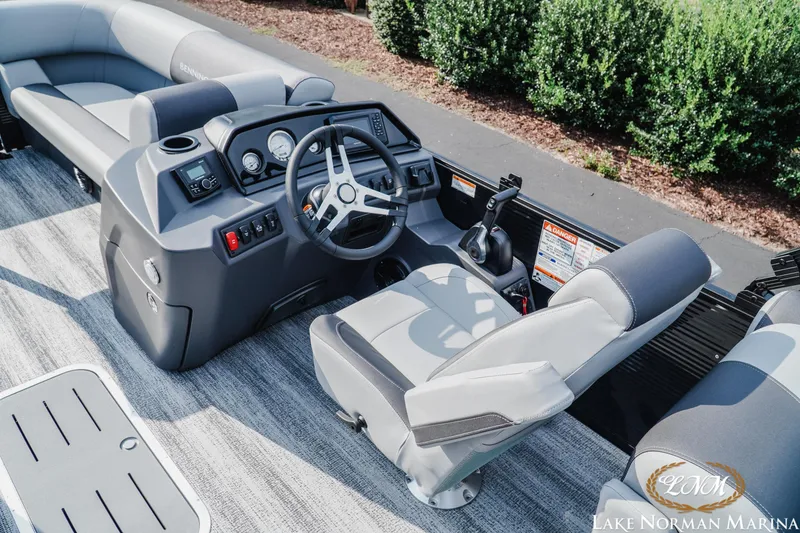 Slide: The Image of 2026 Bennington 22SSR boat interior with steering console and seating at Lake Norman Marina. - 9