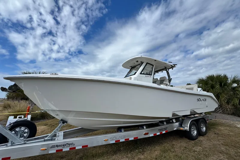The Image of 2026 Solace 30 CS boat on trailer under cloudy sky. - 1