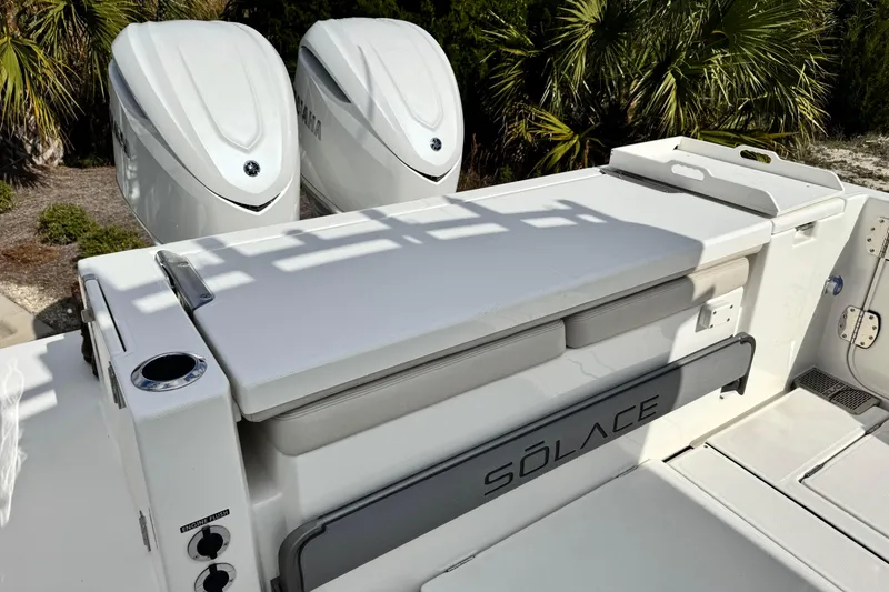 Slide: The Image of 2026 Solace 30 CS boat with dual engines and sleek design in a tropical setting. - 12
