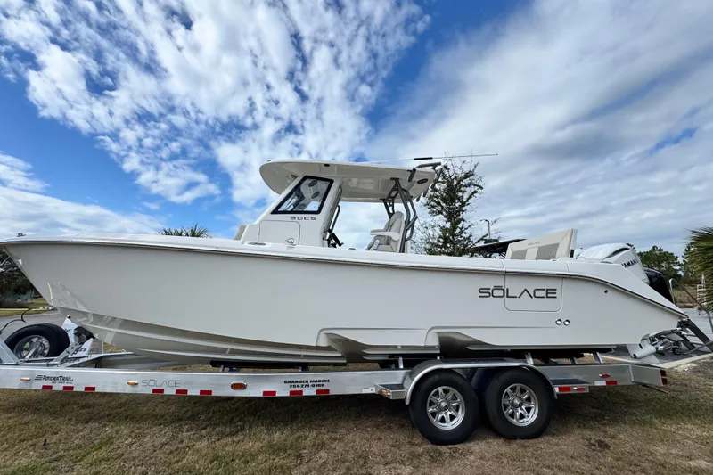 Slide: The Image of 2026 Solace 30 CS boat on trailer under a partly cloudy sky. - 2