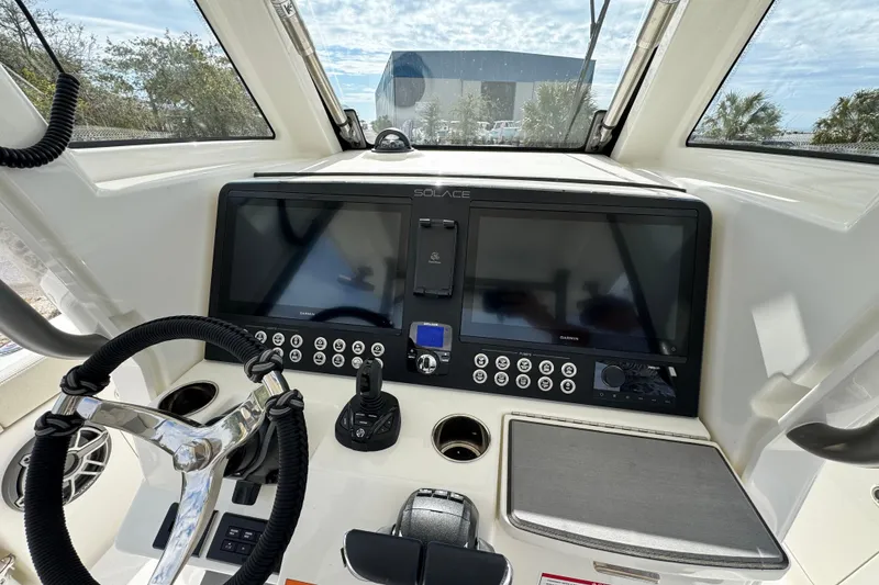 Slide: The Image of 2026 Solace 30 CS boat dashboard with dual screens and steering wheel. - 21