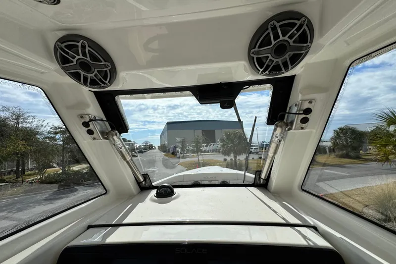 Slide: The Image of Interior view of 2026 Solace 30 CS boat, featuring speakers and windshield. - 22