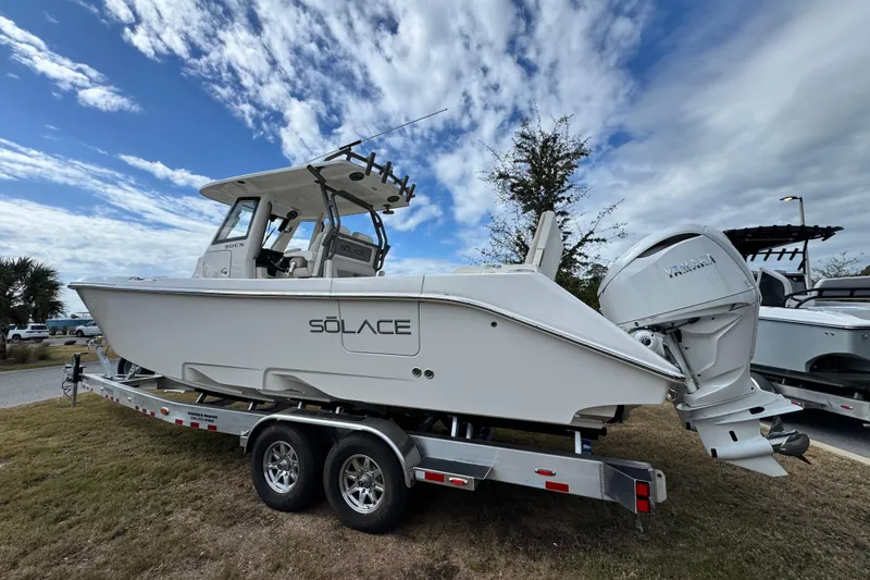 Slide: The Image of 2026 Solace 30 CS boat on trailer under cloudy sky. - 3