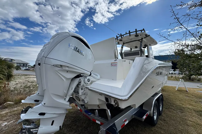 Slide: The Image of 2026 Solace 30 CS boat with Yamaha engine on trailer under blue sky. - 5