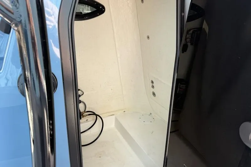 Slide: The Image of 2024 Sea Pro 230 Bay boat interior storage compartment, featuring sleek design and wiring. - 13
