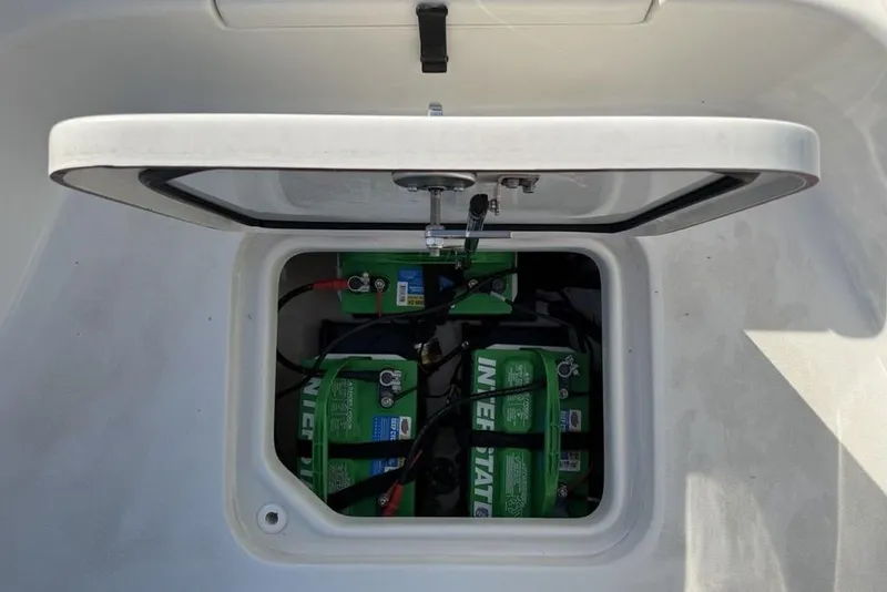 Slide: The Image of 2024 Sea Pro 230 Bay boat battery compartment with Interstate batteries visible. - 14