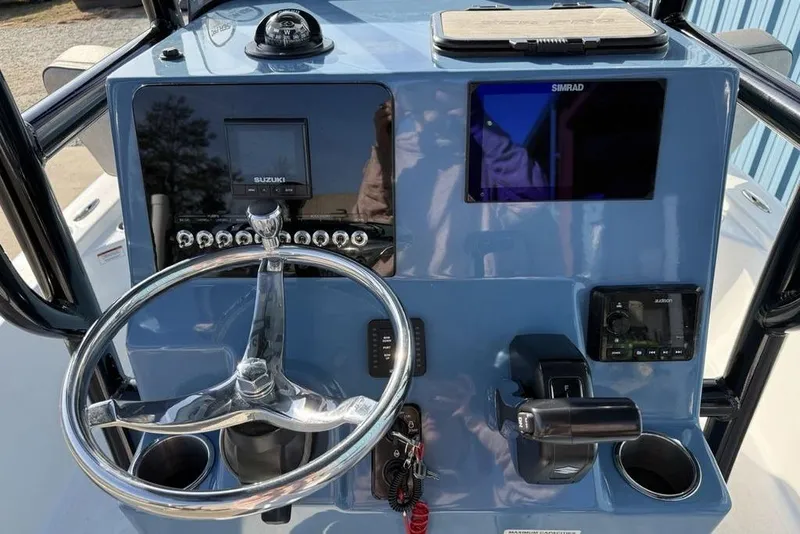 Slide: The Image of 2024 Sea Pro 230 Bay boat dashboard with steering wheel and electronic displays. - 17