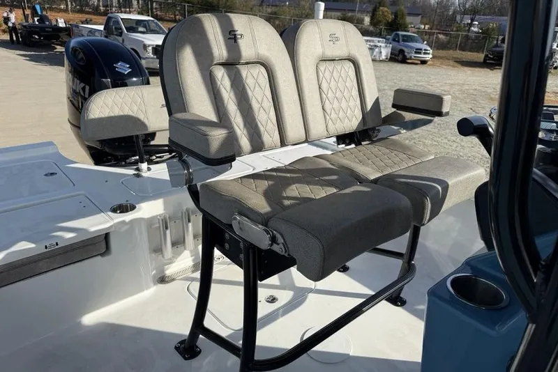 Slide: The Image of 2024 Sea Pro 230 Bay boat with dual cushioned seats and Suzuki outboard motor. - 18