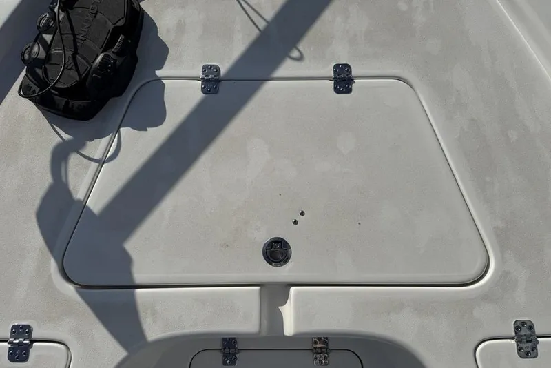 Slide: The Image of 2024 Sea Pro 230 Bay boat deck with storage compartment and equipment. - 21