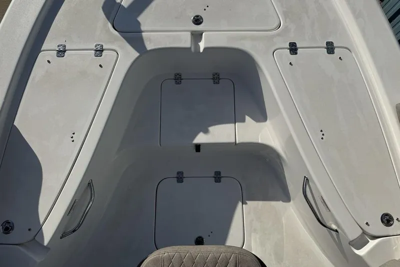 Slide: The Image of 2024 Sea Pro 230 Bay boat interior with storage compartments and seating. - 22