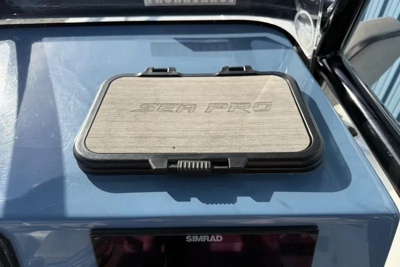 Slide: The Image of 2024 Sea Pro 230 Bay boat dashboard with Sea Pro logo cover. - 26