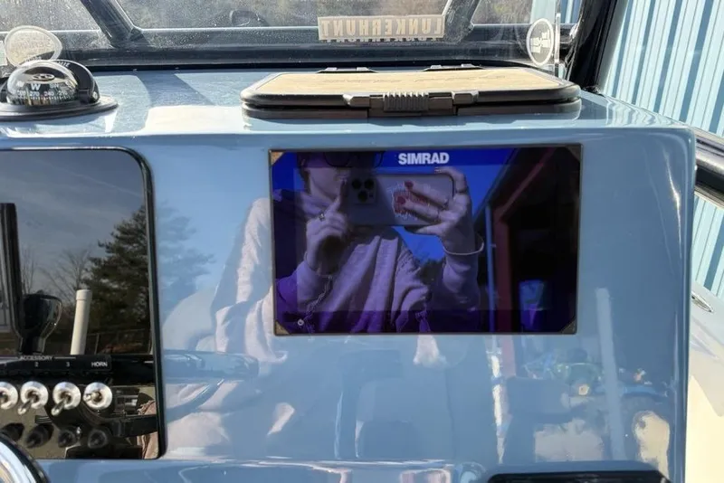 Slide: The Image of Dashboard of 2024 Sea Pro 230 Bay boat with Simrad display and compass. - 28