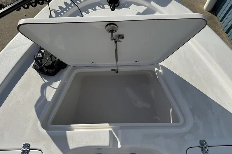 Slide: The Image of Open storage compartment on 2024 Sea Pro 230 Bay boat deck. - 30