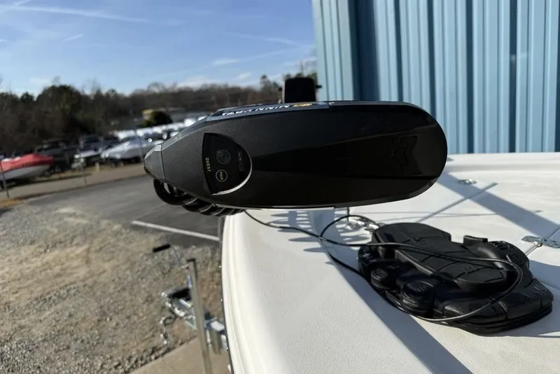 Slide: The Image of 2024 Sea Pro 230 Bay boat with trolling motor, docked near blue building. - 32