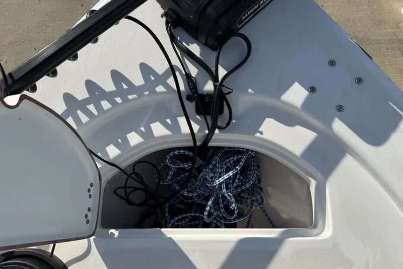 Slide: The Image of 2024 Sea Pro 230 Bay boat storage compartment with ropes and cables. - 34