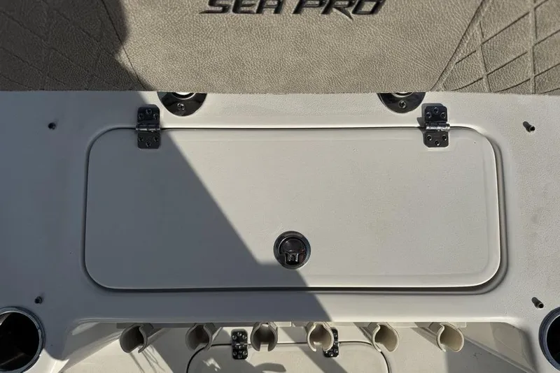 Slide: The Image of 2024 Sea Pro 230 Bay boat interior with storage compartment and cup holders. - 35