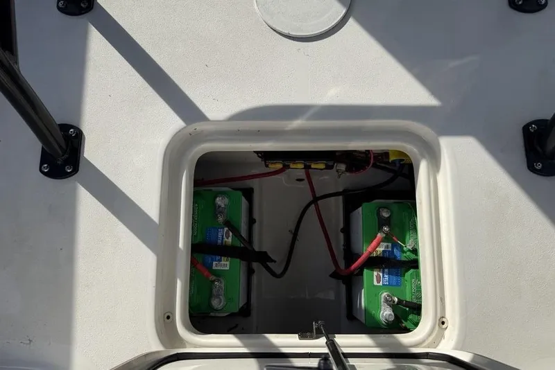 Slide: The Image of 2024 Sea Pro 230 Bay boat battery compartment with dual batteries and wiring. - 36