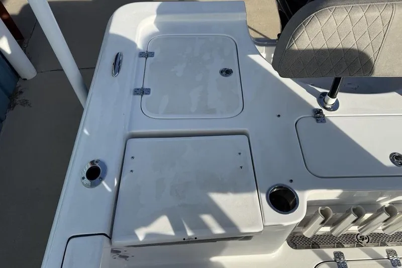 Slide: The Image of 2024 Sea Pro 230 Bay boat deck with storage compartments and seating. - 38