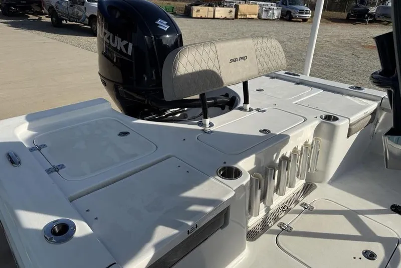 Slide: The Image of 2024 Sea Pro 230 Bay boat deck with Suzuki engine and rod holders. - 39