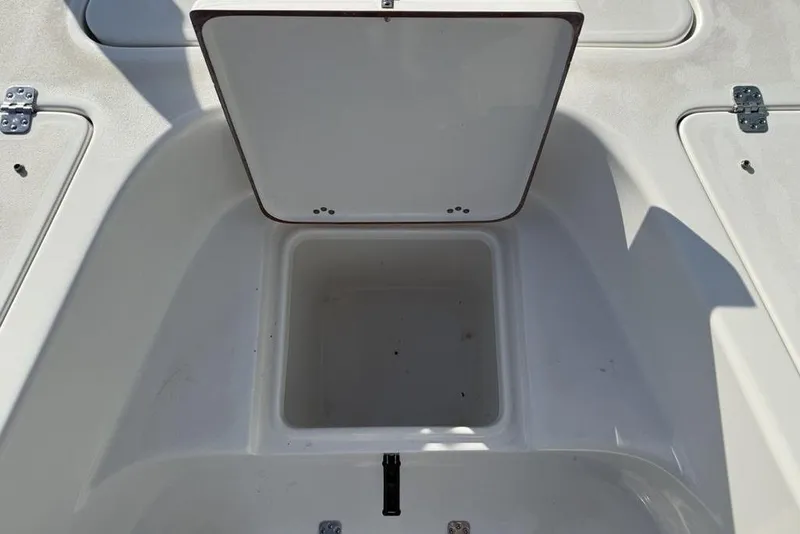 Slide: The Image of 2024 Sea Pro 230 Bay boat storage compartment with open lid, showcasing interior space. - 4