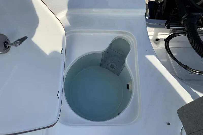 Slide: The Image of Livewell compartment on 2024 Sea Pro 230 Bay boat, featuring a clean, white design. - 40