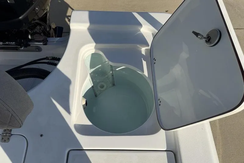 Slide: The Image of 2024 Sea Pro 230 Bay boat livewell with open lid, showcasing interior design. - 45