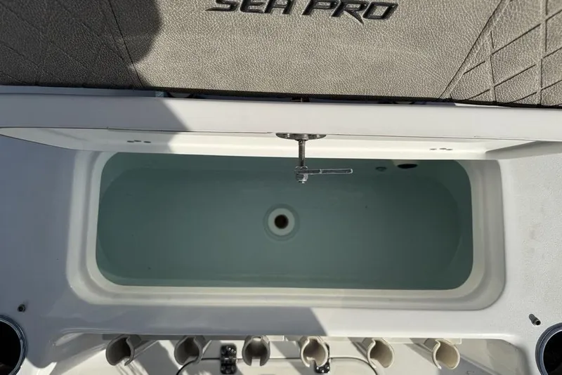 Slide: The Image of 2024 Sea Pro 230 Bay boat livewell with rod holders and storage. - 46