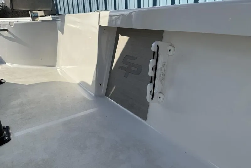 Slide: The Image of 2024 Sea Pro 230 Bay boat interior, featuring sleek white design and storage compartment. - 48