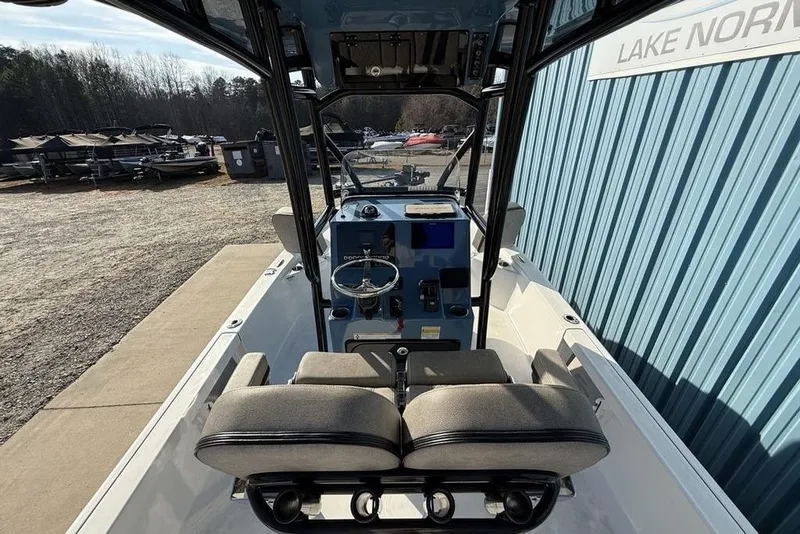 Slide: The Image of 2024 Sea Pro 230 Bay boat interior with steering console and seating, parked near Lake Norman. - 49